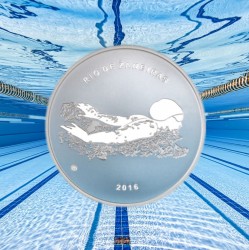 On Olympic coin — image of a girl swimming towards victory